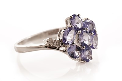 Lot 112 - A tanzanite and diamond flower cluster dress ring