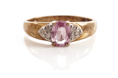 Lot 113 - A fancy pink sapphire and diamond dress ring