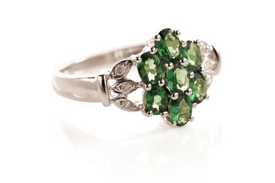 Lot 114 - A grossular garnet and diamond flower cluster ring