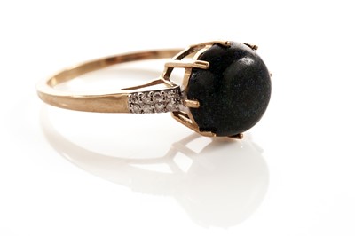 Lot 115 - A black boulder opal and diamond dress ring