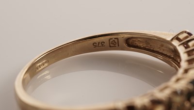 Lot 117 - A pair of coloured stone set half hoop eternity rings