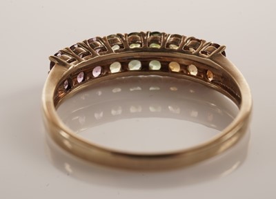 Lot 117 - A pair of coloured stone set half hoop eternity rings