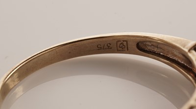 Lot 117 - A pair of coloured stone set half hoop eternity rings