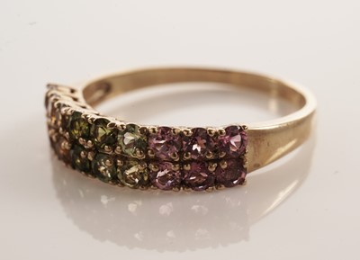Lot 117 - A pair of coloured stone set half hoop eternity rings
