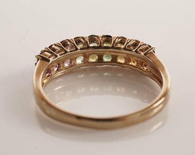 Lot 117 - A pair of coloured stone set half hoop eternity rings