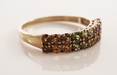 Lot 117 - A pair of coloured stone set half hoop eternity rings
