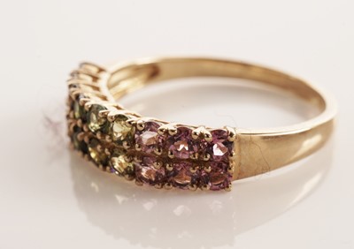 Lot 117 - A pair of coloured stone set half hoop eternity rings