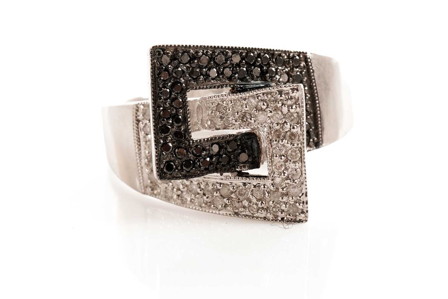 Lot 119 - A diamond and black diamond dress ring