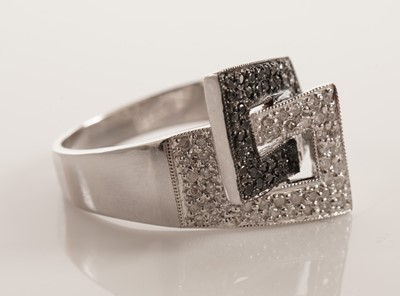 Lot 119 - A diamond and black diamond dress ring