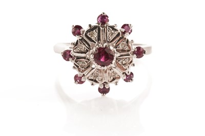 Lot 121 - A ruby and diamond cluster ring