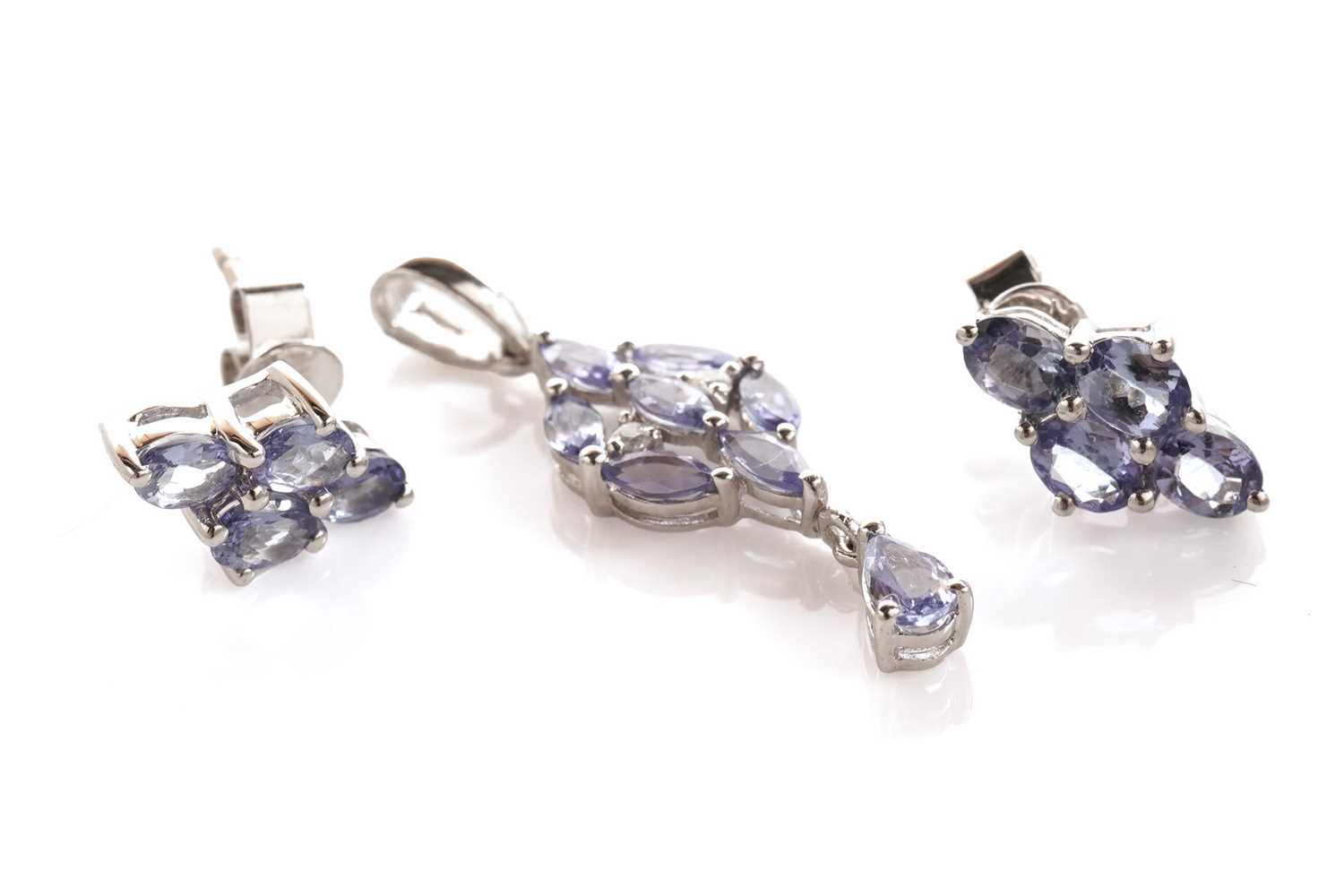 Lot 130 - A tanzanite and diamond pendant; and a pair of tanzanite earrings