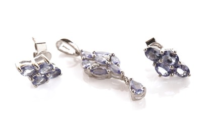 Lot 130 - A tanzanite and diamond pendant; and a pair of tanzanite earrings