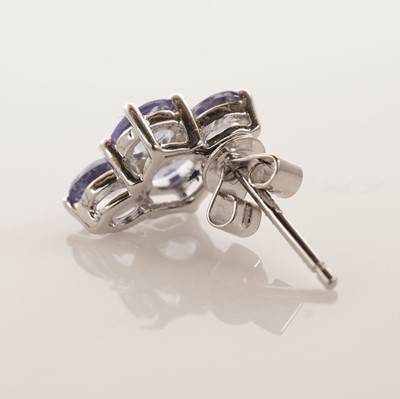 Lot 130 - A tanzanite and diamond pendant; and a pair of tanzanite earrings