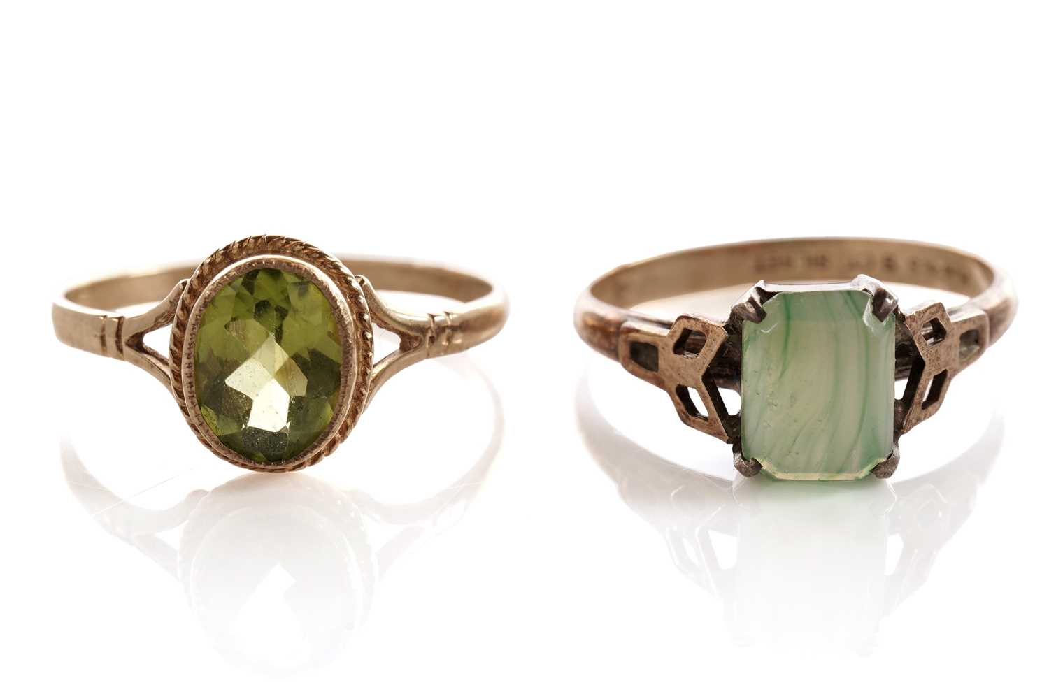 Lot 134 - A peridot single stone ring; and another ring