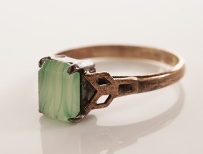 Lot 134 - A peridot single stone ring; and another ring