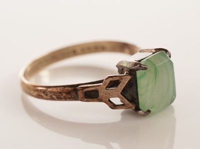 Lot 134 - A peridot single stone ring; and another ring