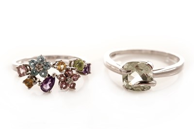 Lot 135 - A flower cluster dress ring; and a single stone dress ring