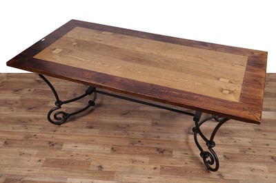 Lot 110 - A modern oak and wrought metal dining table