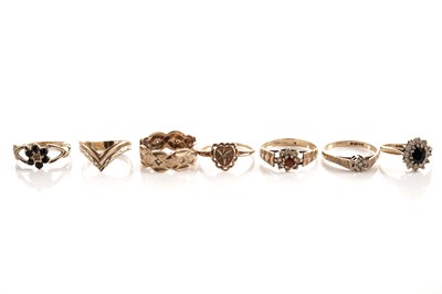 Lot 104 - A star set diamond heart pattern dress ring; and a selection of 9ct gold rings