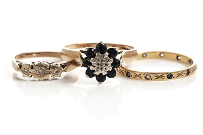 Lot 183 - A sapphire and diamond flower cluster ring; and two other rings