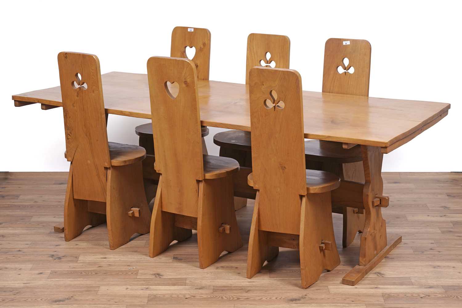 Lot 55 - An unusual and distinctive elm dining table and six chairs