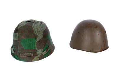 Lot 198 - A German M40 pattern helmet and an American helmet