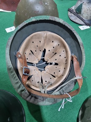 Lot 198 - A German M40 pattern helmet and an American helmet