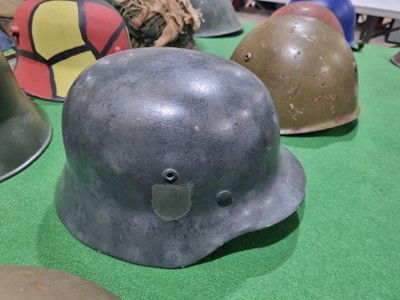 Lot 198 - A German M40 pattern helmet and an American helmet