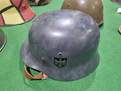 Lot 198 - A German M40 pattern helmet and an American helmet
