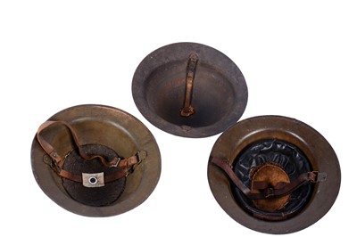 Lot 191 - Two Brodie helmets; and another