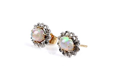 Lot 622 - A pair of opal and diamond cluster earrings