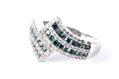 Lot 751 - A diamond and blue diamond half eternity ring