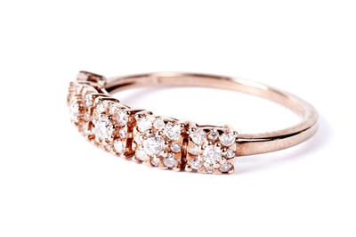 Lot 749 - A diamond flower cluster half hoop eternity ring