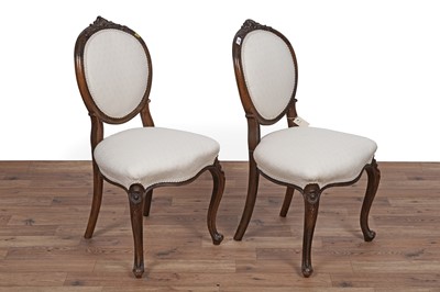 Lot 26 - A set of four Victorian carved walnut salon chairs