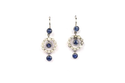 Lot 816 - A pair of early 20th Century sapphire and seed-pearl drop earrings