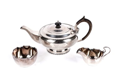 Lot 346 - A George V silver tea pot; together with a cream jug and sugar bowl