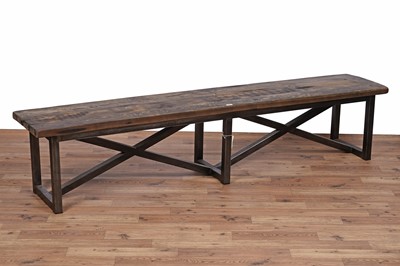 Lot 17 - An industrial style oak dining table and bench