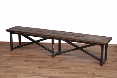 Lot 17 - An industrial style oak dining table and bench