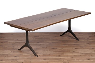 Lot 17 - An industrial style oak dining table and bench