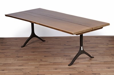 Lot 17 - An industrial style oak dining table and bench