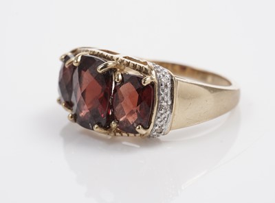 Lot 607 - A garnet and diamond dress ring