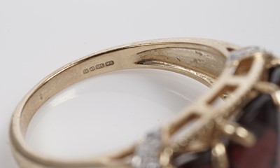 Lot 607 - A garnet and diamond dress ring
