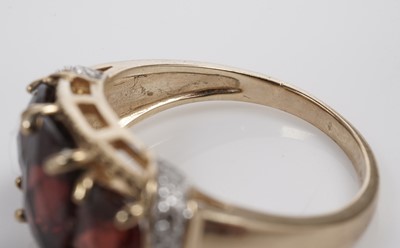 Lot 607 - A garnet and diamond dress ring