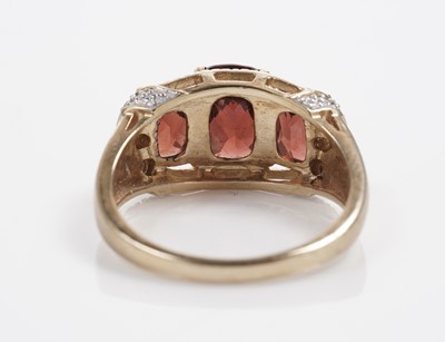 Lot 607 - A garnet and diamond dress ring