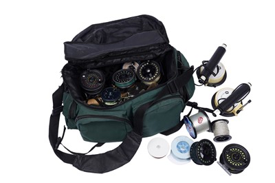 Lot 372 - A fishing tackle bag containing a selection of fly reels; and other items