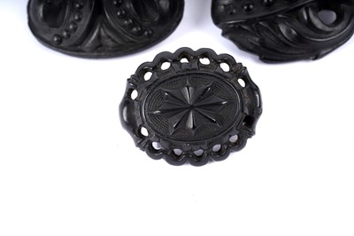 Lot 1492 - Nine Victorian Etruscan revival jet and faux jet brooches