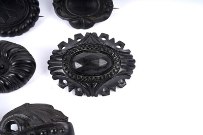 Lot 1492 - Nine Victorian Etruscan revival jet and faux jet brooches
