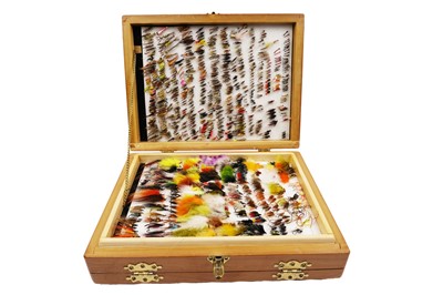 Lot 381 - A double hinged fly reservoir containing a collection of salmon and trout flies, nymphs and lures