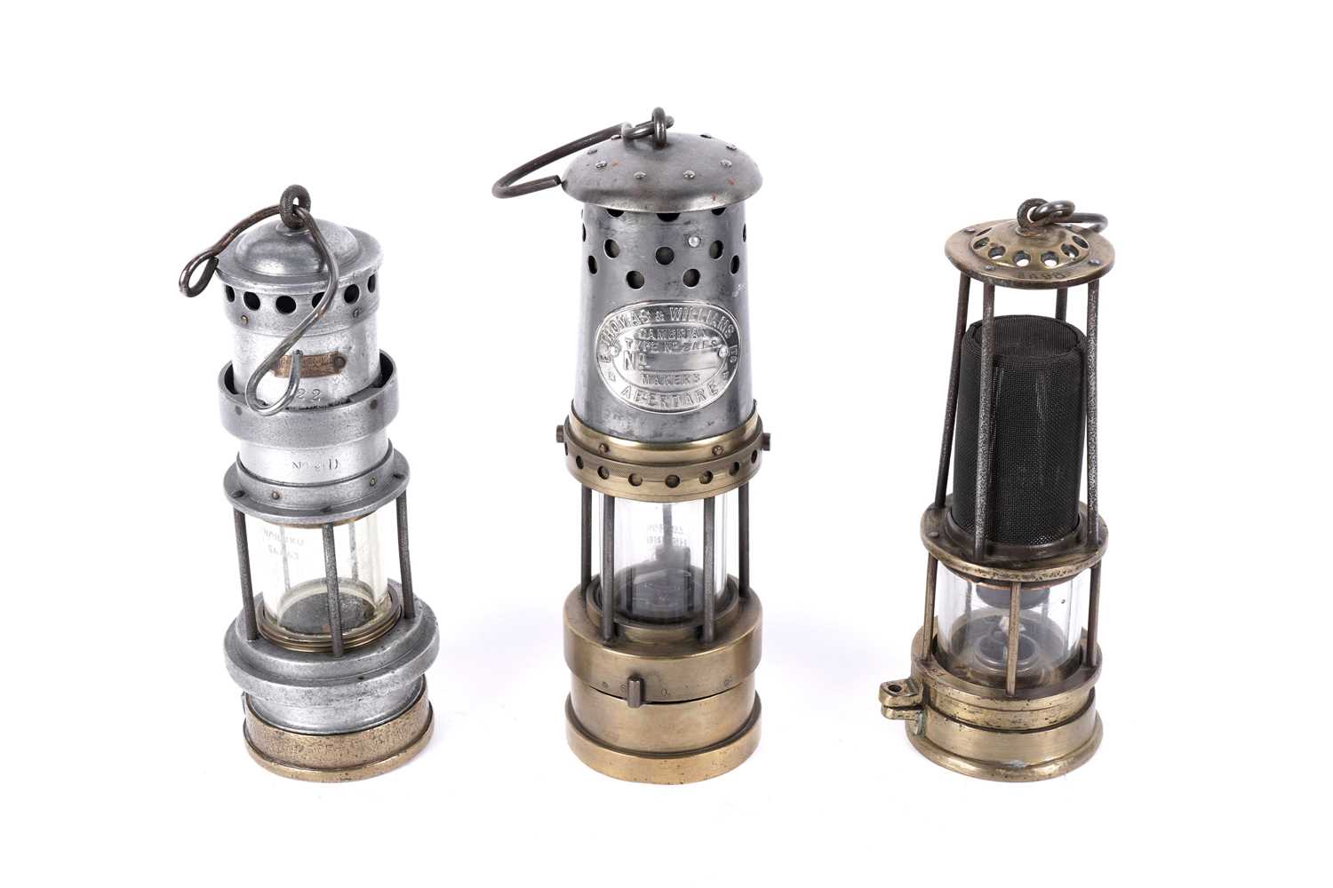 Lot 1443 - Three miners’ lamps; together with a Clanny style lamp