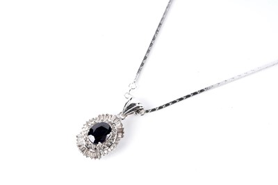 Lot 700 - A sapphire and diamond cluster pendant